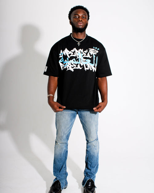 Person wearing a black t-shirt with white text and blue jeans on a white background