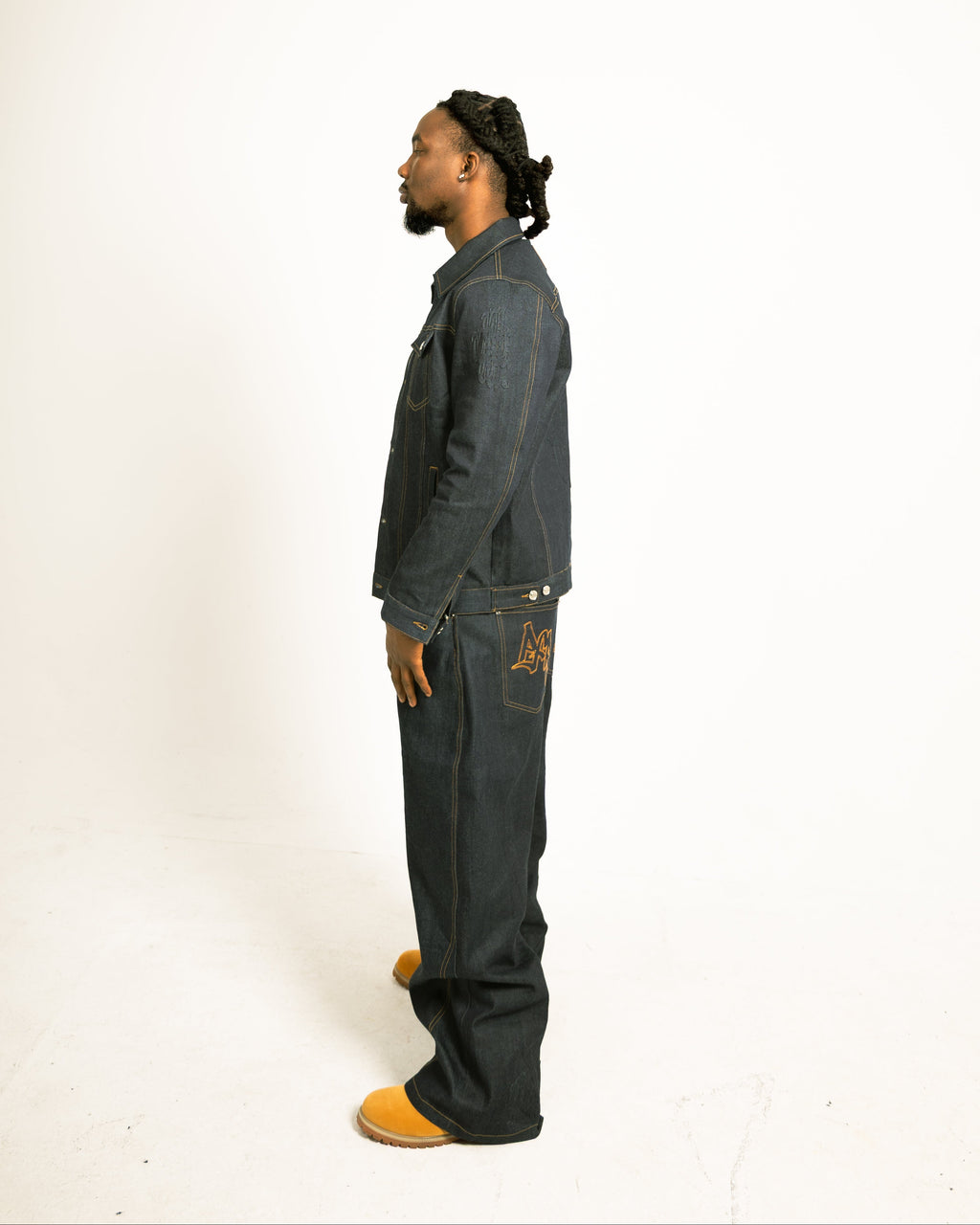 Man wearing a gray outfit with a logo on a white background